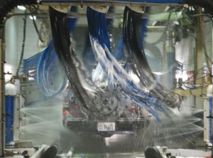 Photo of carwash scrubbers washing a truck.